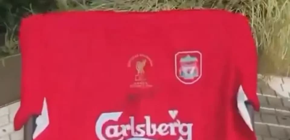 Liverpool FC jersey displayed outdoors on a chair