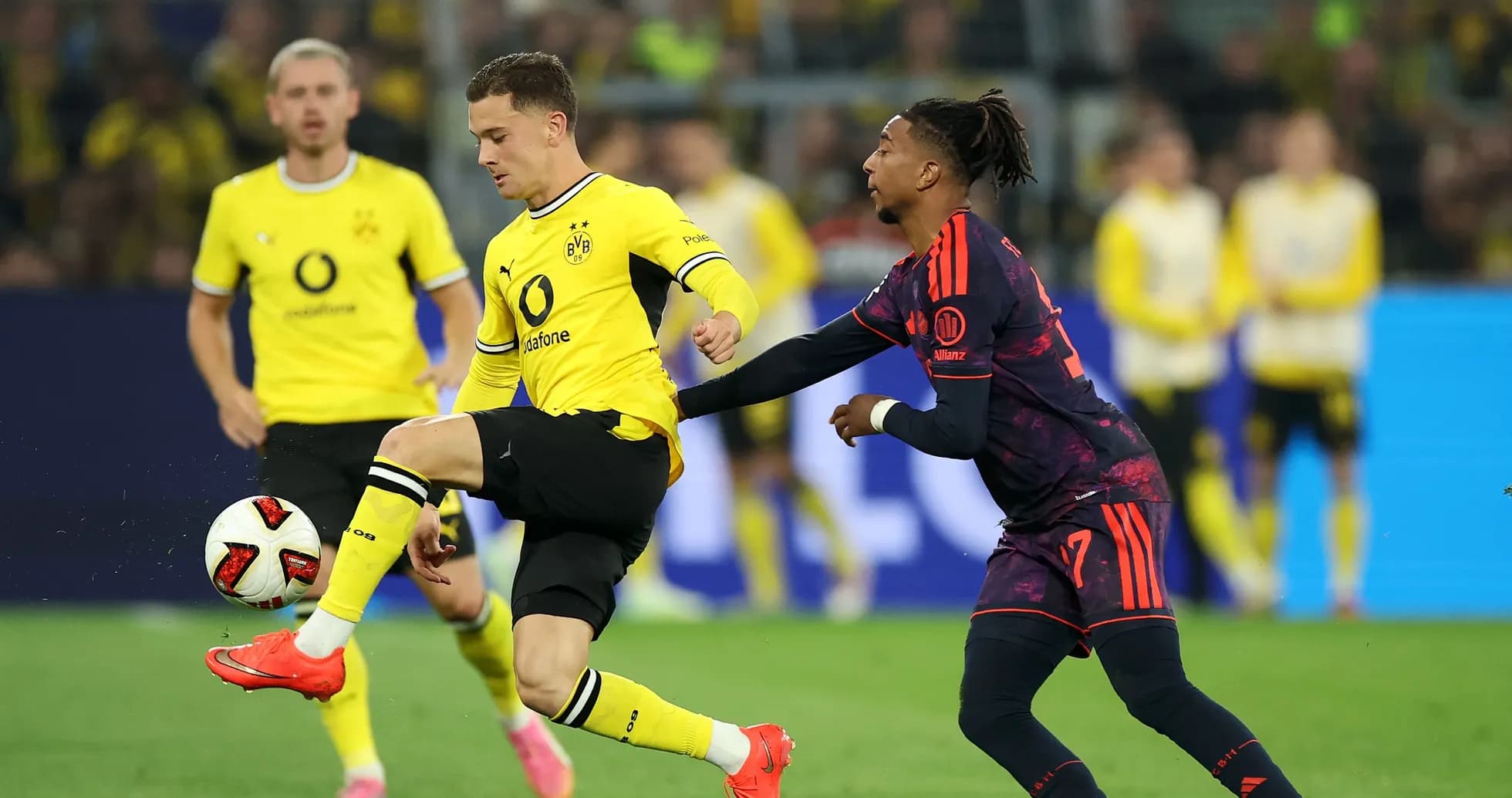 Игроки Borussia Dortmund и соперник борются за мяч