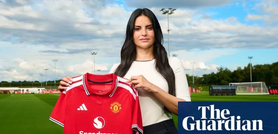 Женщина держит футболку Manchester United на тренировочном поле