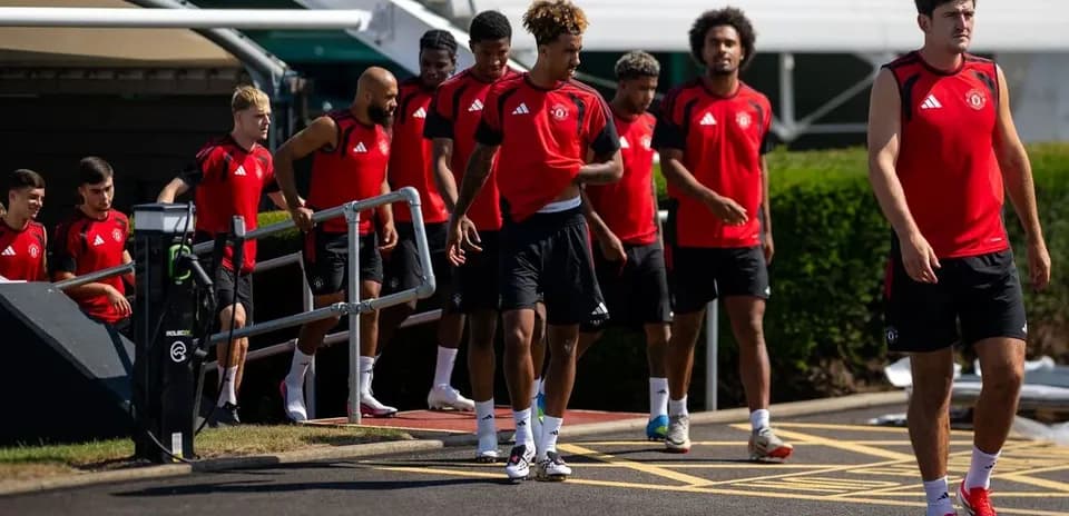 Игроки Manchester United в тренировочной одежде на выходе