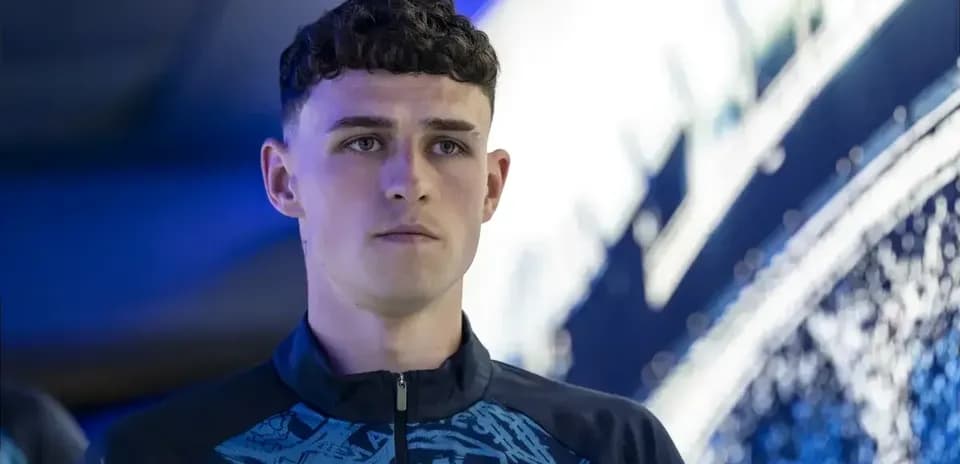 Игрок Manchester City на фоне клубного логотипа