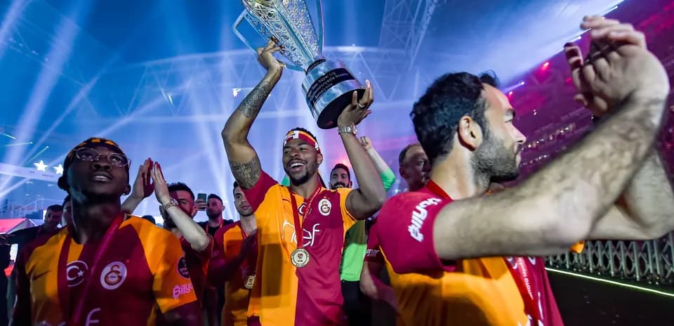 Игроки Galatasaray празднуют с трофеем на стадионе