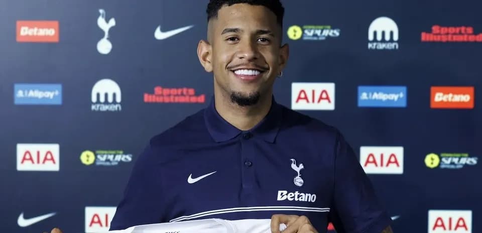 Игрок держит футболку Tottenham Hotspur на презентации