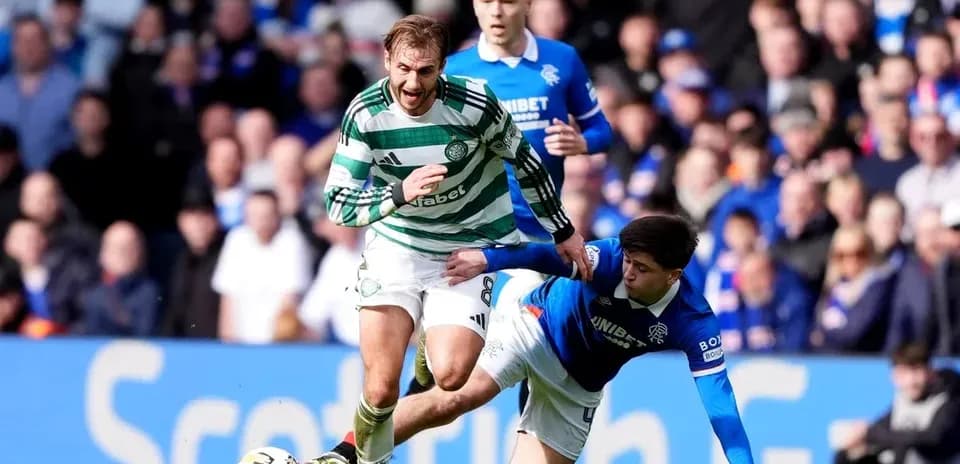 Игроки Celtic и Rangers борются за мяч на поле