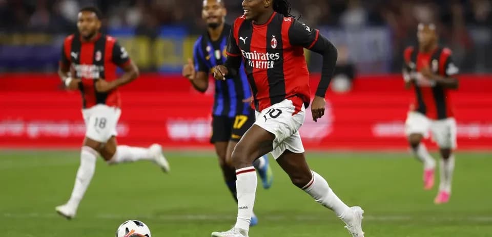 Игрок AC Milan бежит с мячом по полю