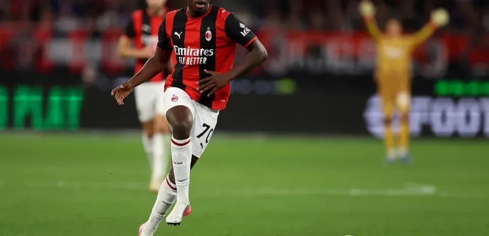Игрок AC Milan бежит с мячом по полю