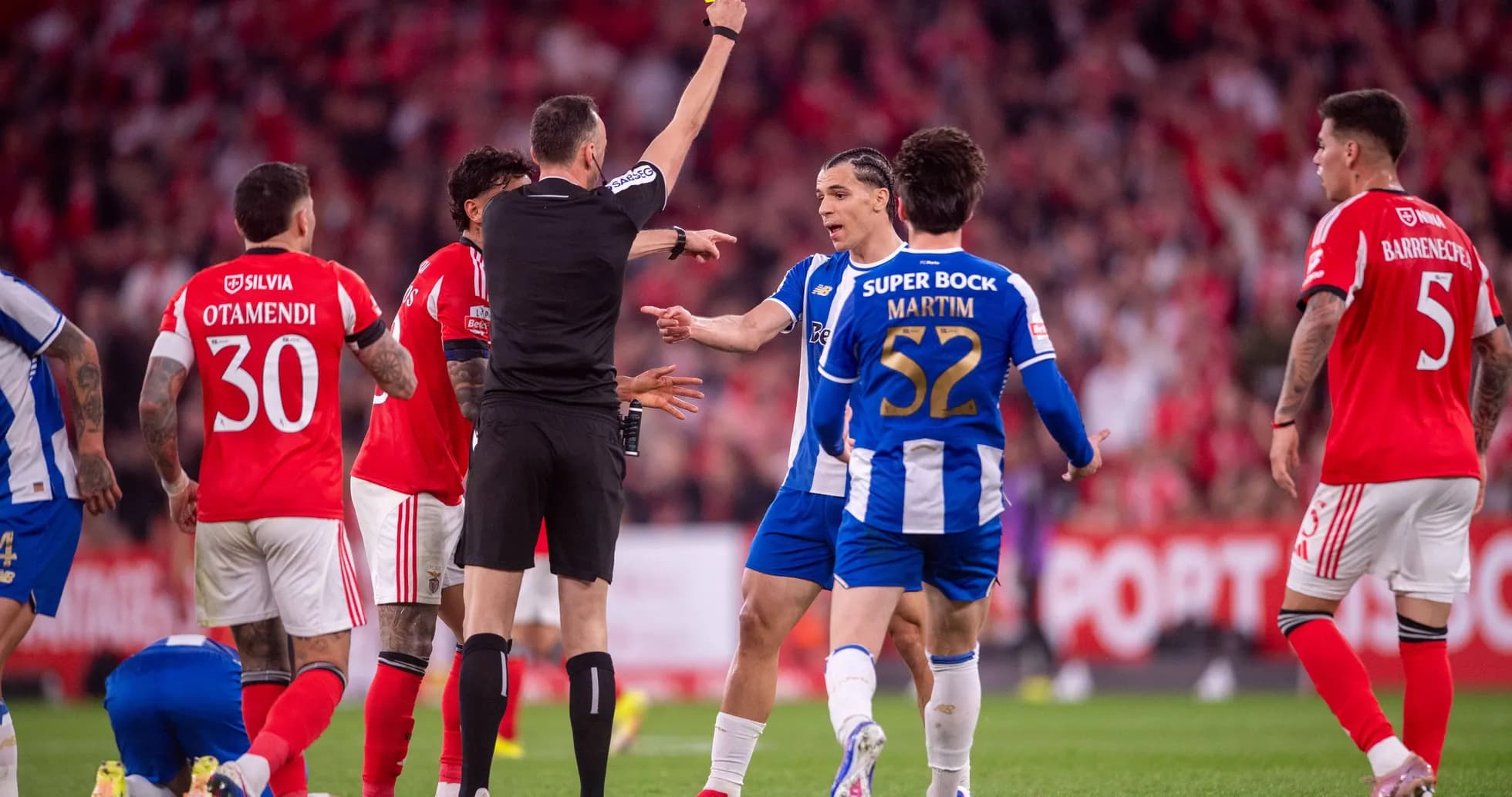 Referee showing yellow card during football match