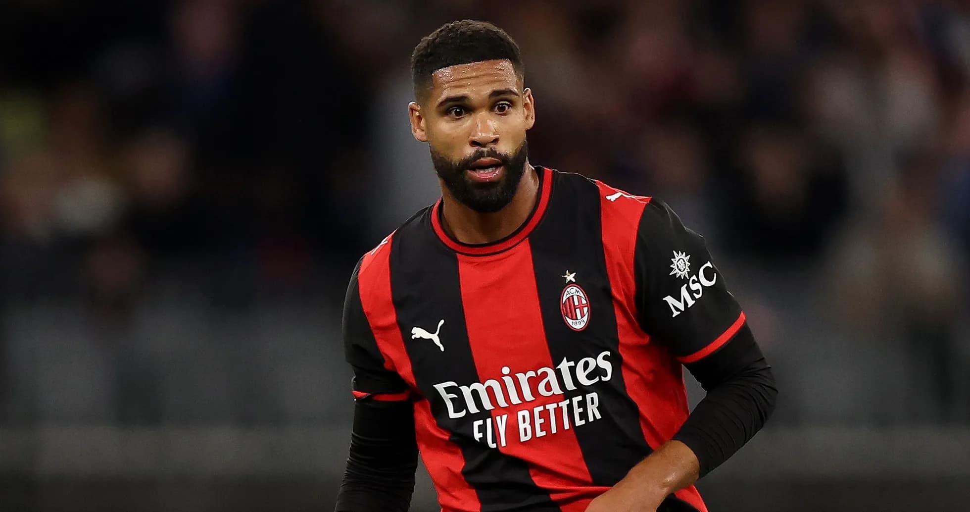 Игрок в черно-красной форме AC Milan на поле Игрок в черно-красной форме AC Milan на поле